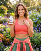 Woman in a garden holding a bottle of MyPowerVita